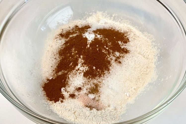 Dry ingredients for banana apple muffins in a bowl.