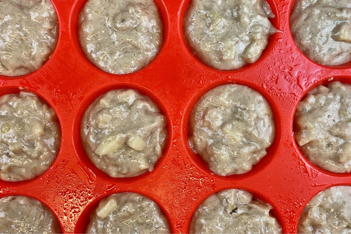 Banana apple muffin batter in muffin pan.