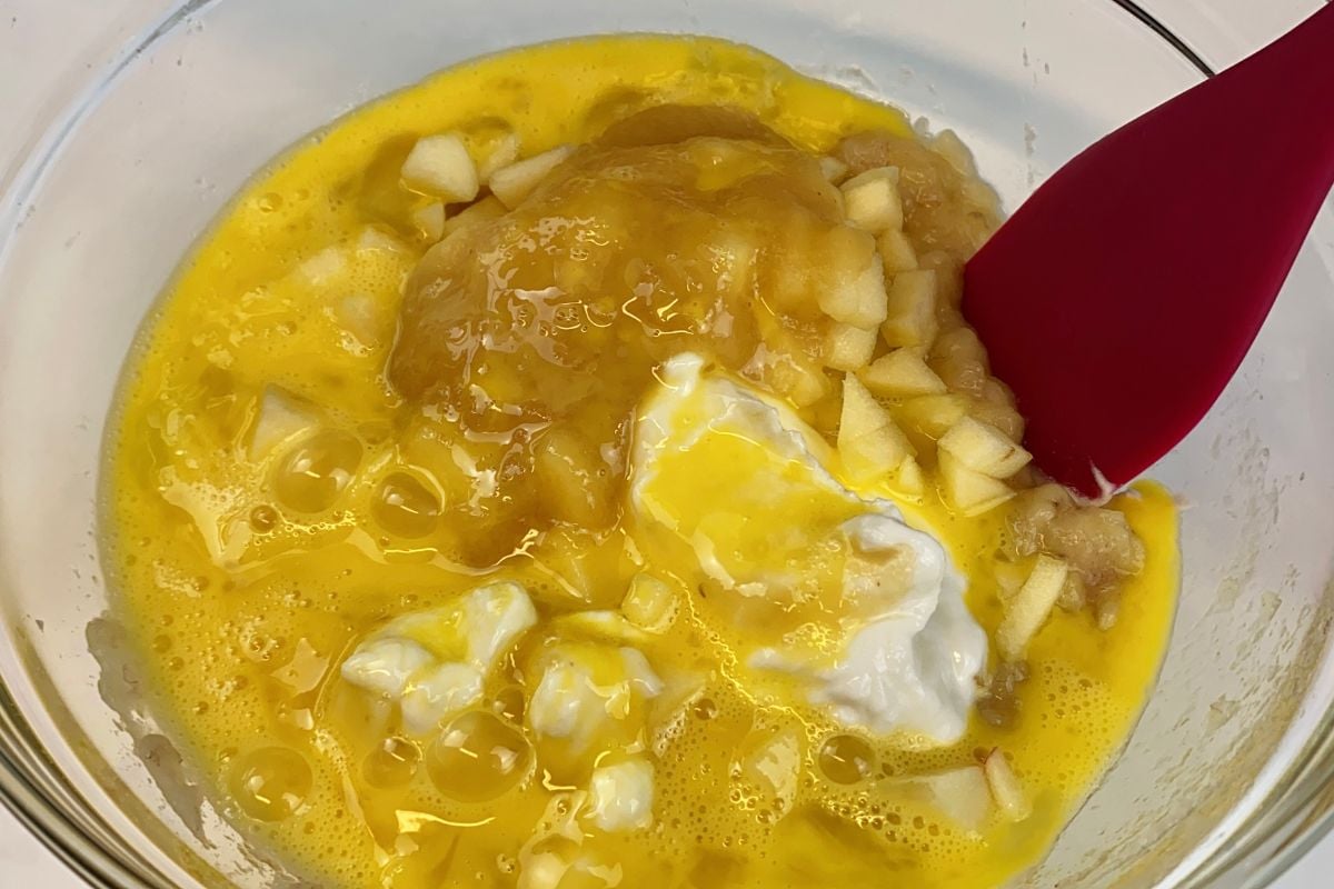 Wet ingredients for banana apple muffins in bowl.