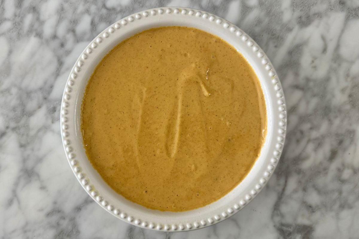 Pumpkin cheesecake batter in dish | Healthy Foodie Girl Pumpkin cheesecake batter in a dish.
