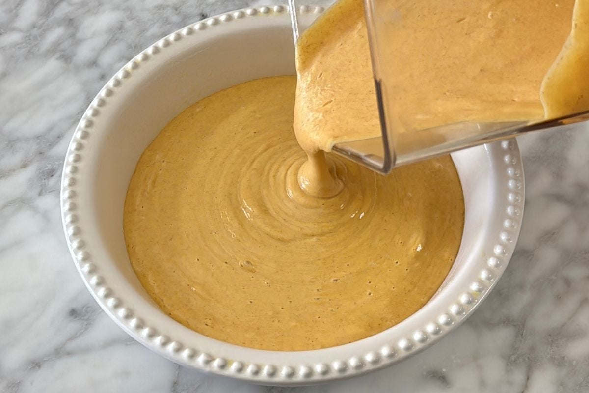 Pumpkin cheesecake poured in baking dish | Healthy Foodie Girl Pumpkin cheesecake poured in a baking dish.