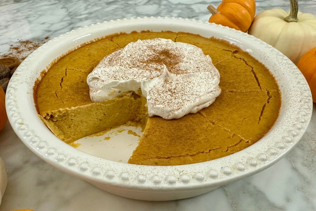 Sliced pumpkin cheesecake in a dish | Healthy Foodie Girl Sliced pumpkin cheesecake in a dish.