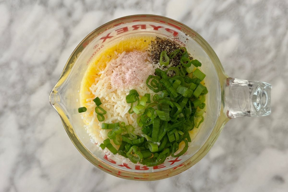 Whisked eggs with ingredients for egg bites
