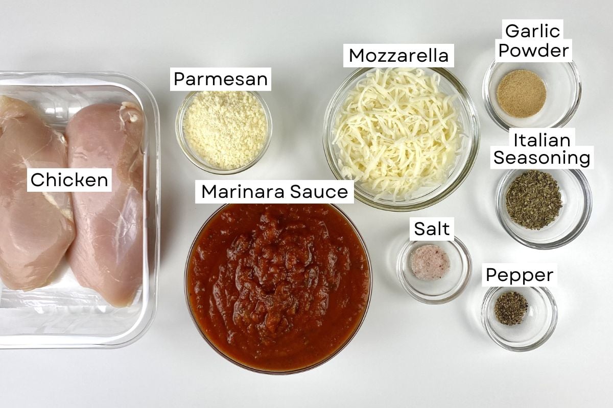 Ingredients needed for slow cooker chicken parmesan in bowls.