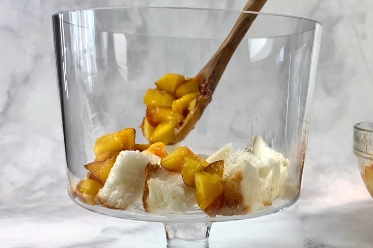 Chopped angel food cake in a trifle dish.