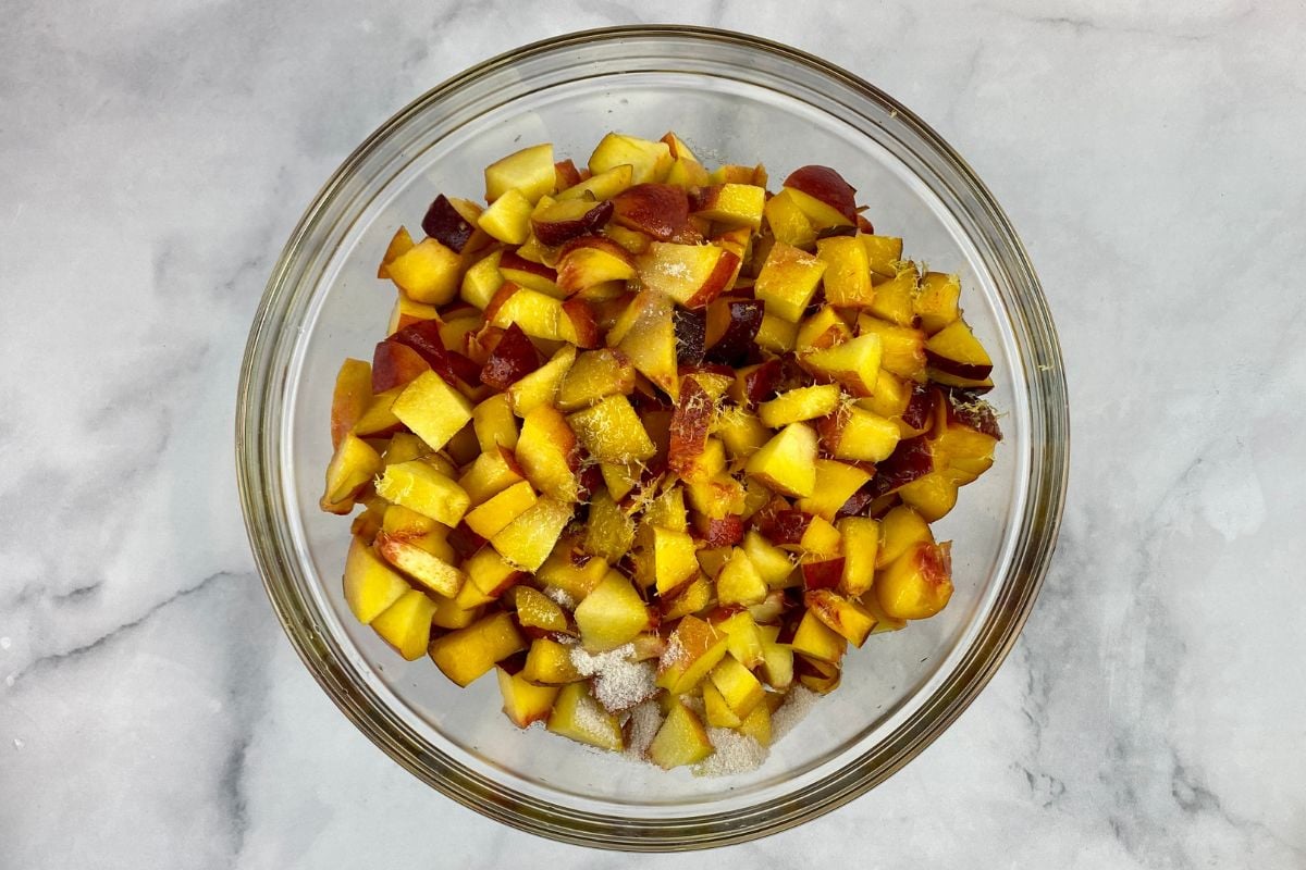 Chopped peaches for peach trifle in a bowl.