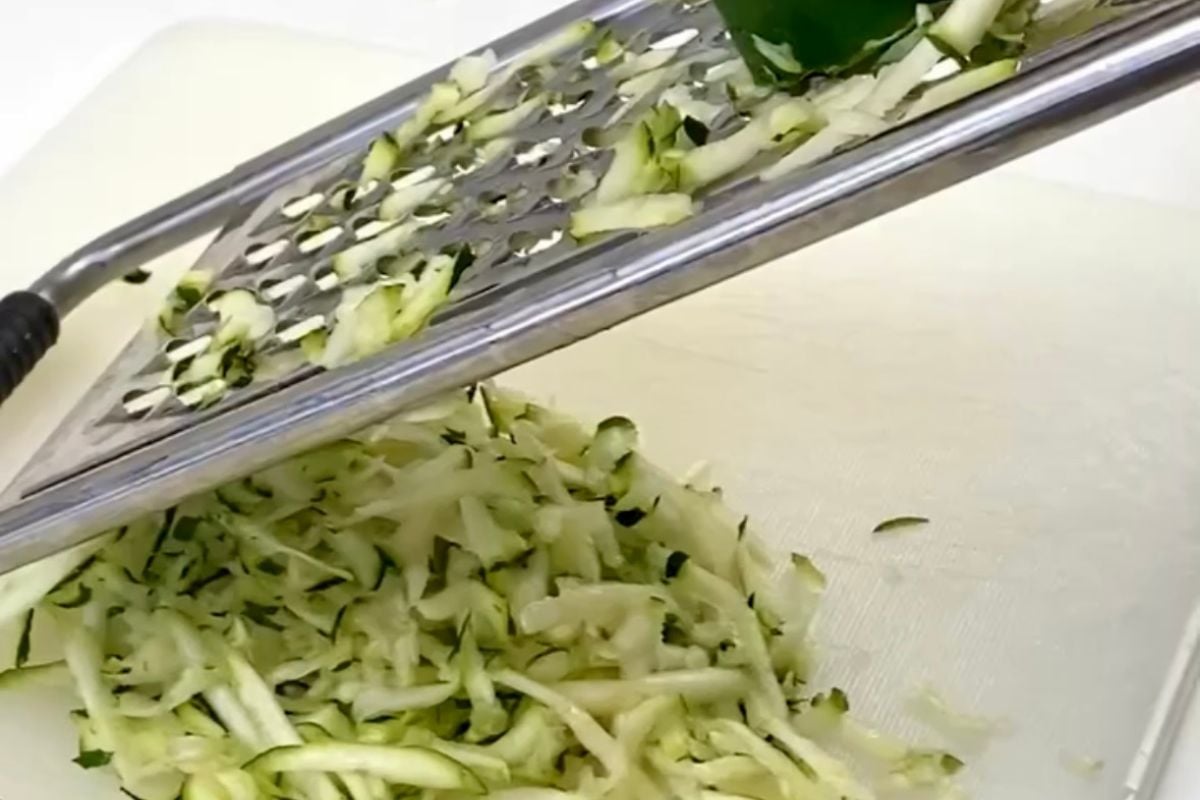 Grated zucchini on a cutting board.