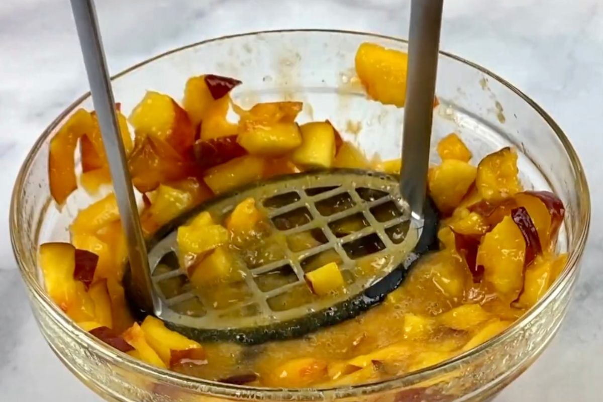 Mashed peaches in a bowl for trifle.