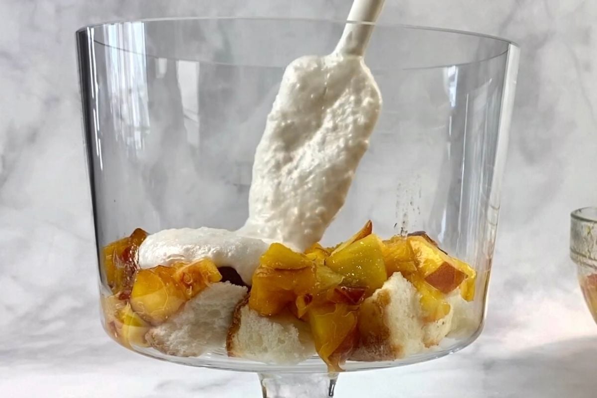 Peaches and pudding mixture in peach trifle dish.