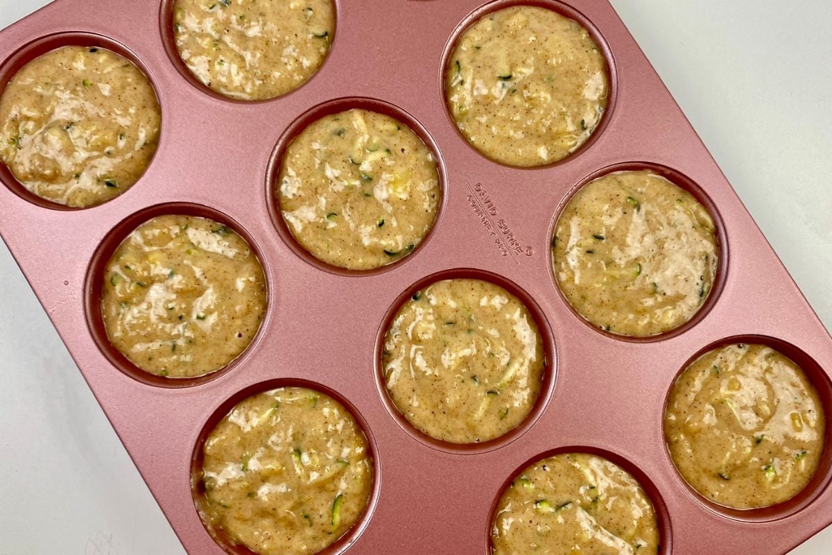Zucchini banana muffin batter in muffin pan.