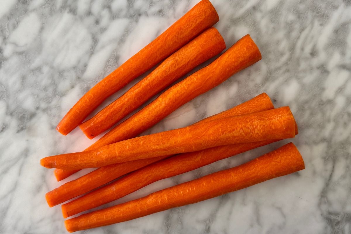 Peeled carrots for banana carrot muffins.