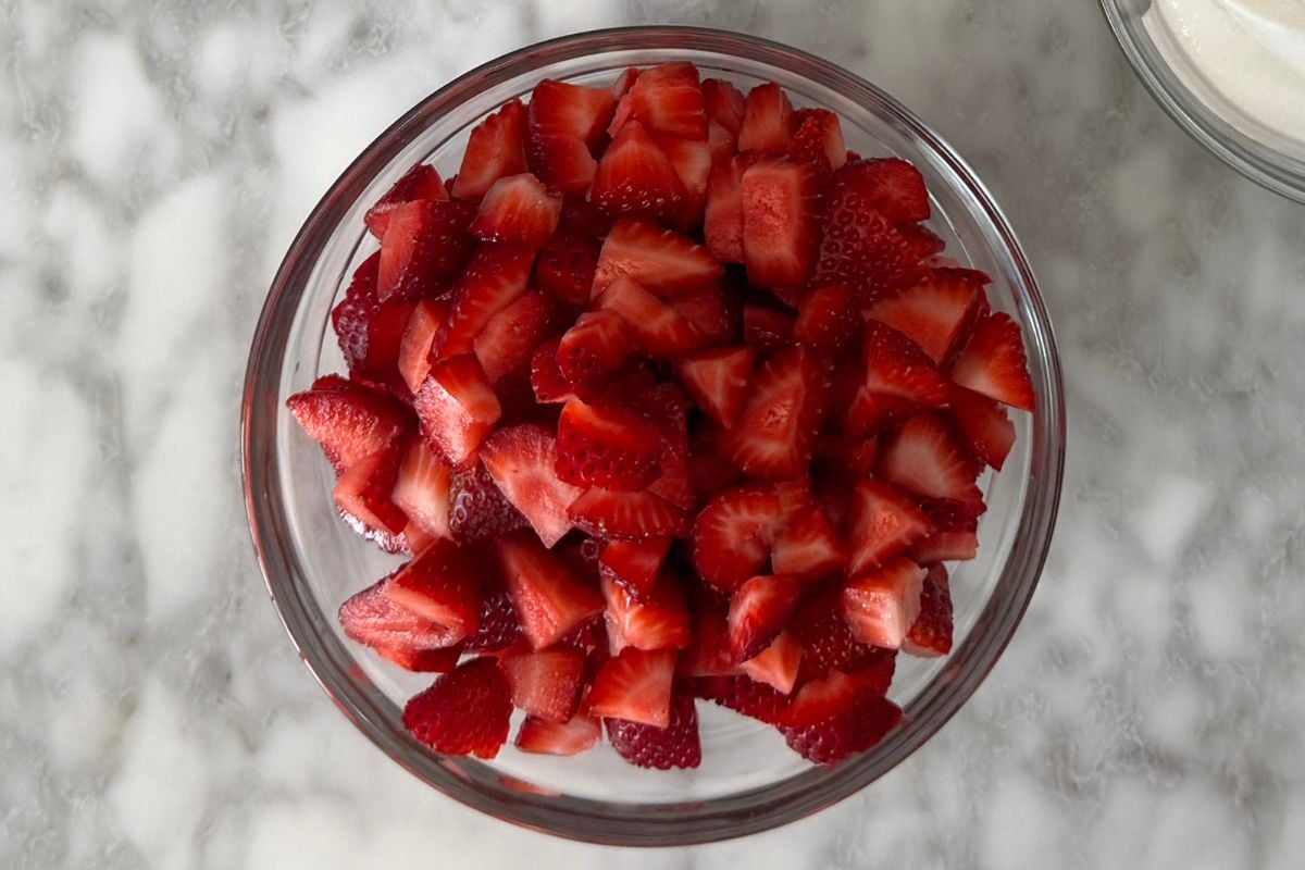 Chopped strawberries for icebox cake in a bowl.