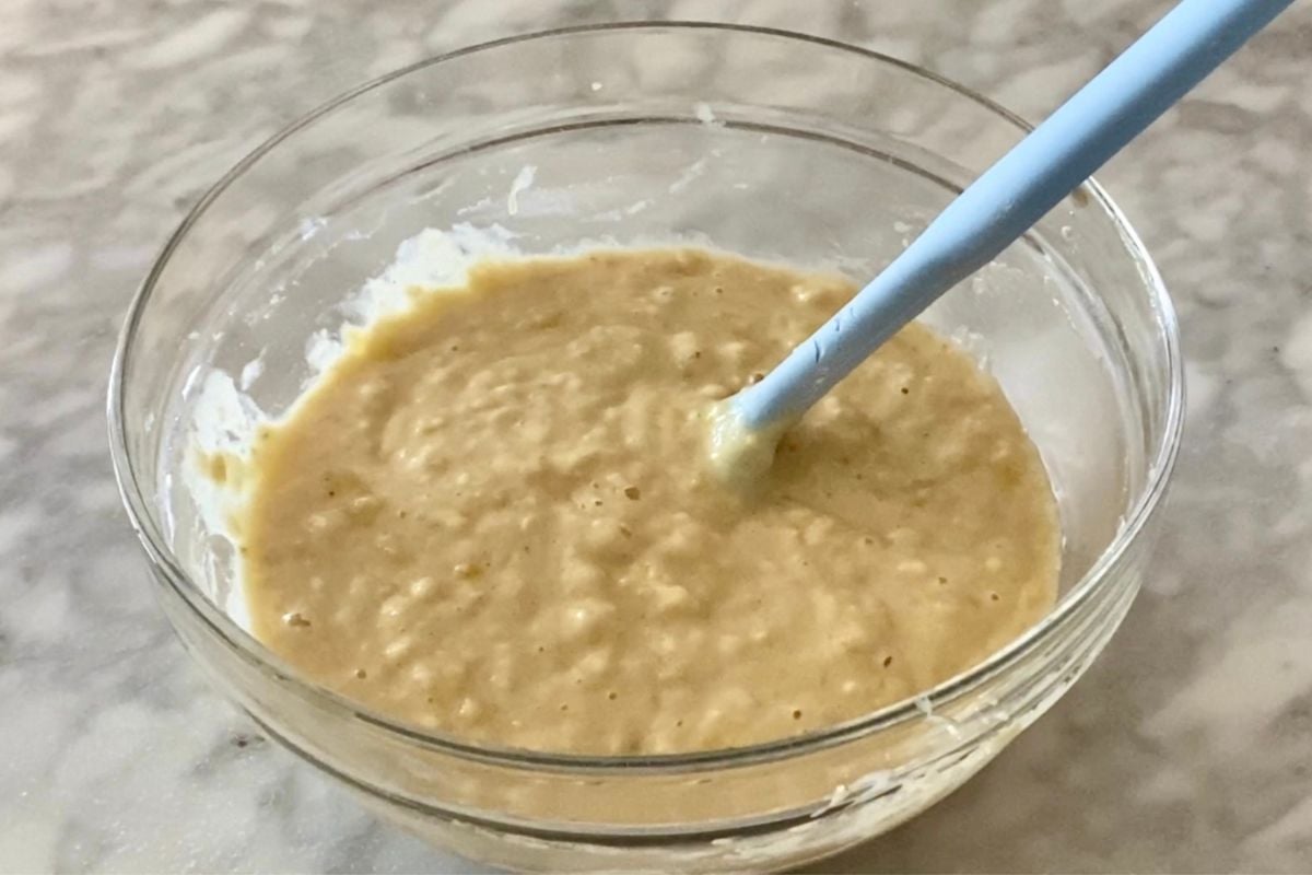 Combined muffin batter for banana muffins with strawberries.