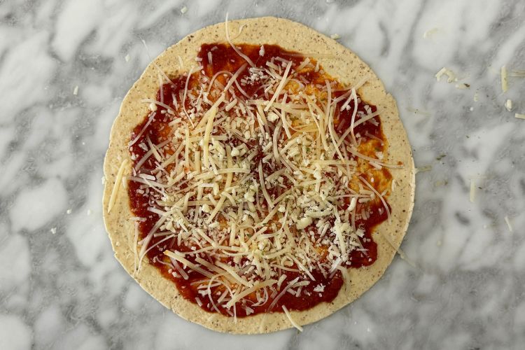 Cheese and sauce on tortilla