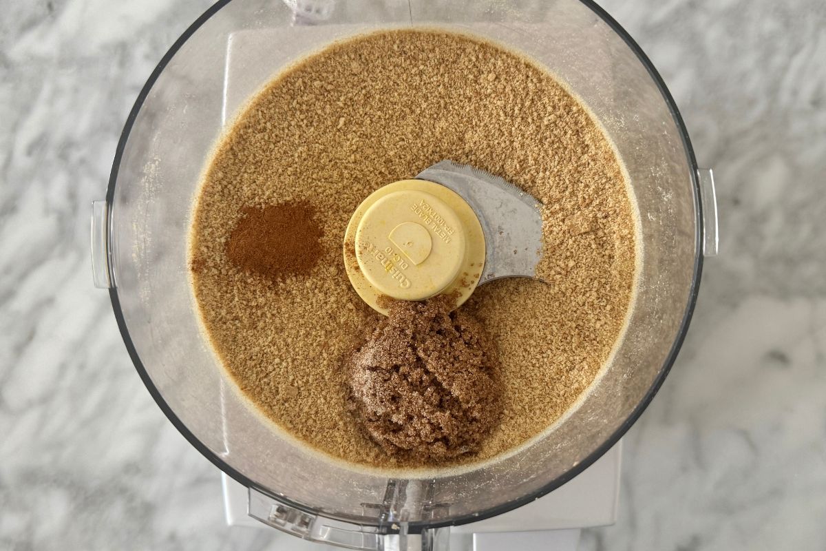Pulsed graham crackers cinnamon and sweetener in food processor.