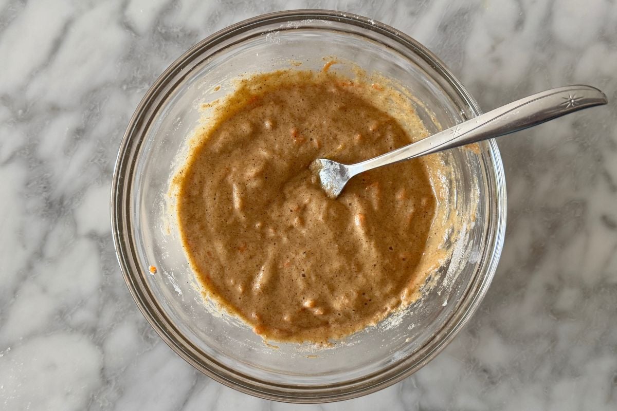 Mixed carrot cake mug cake batter in a bowl.