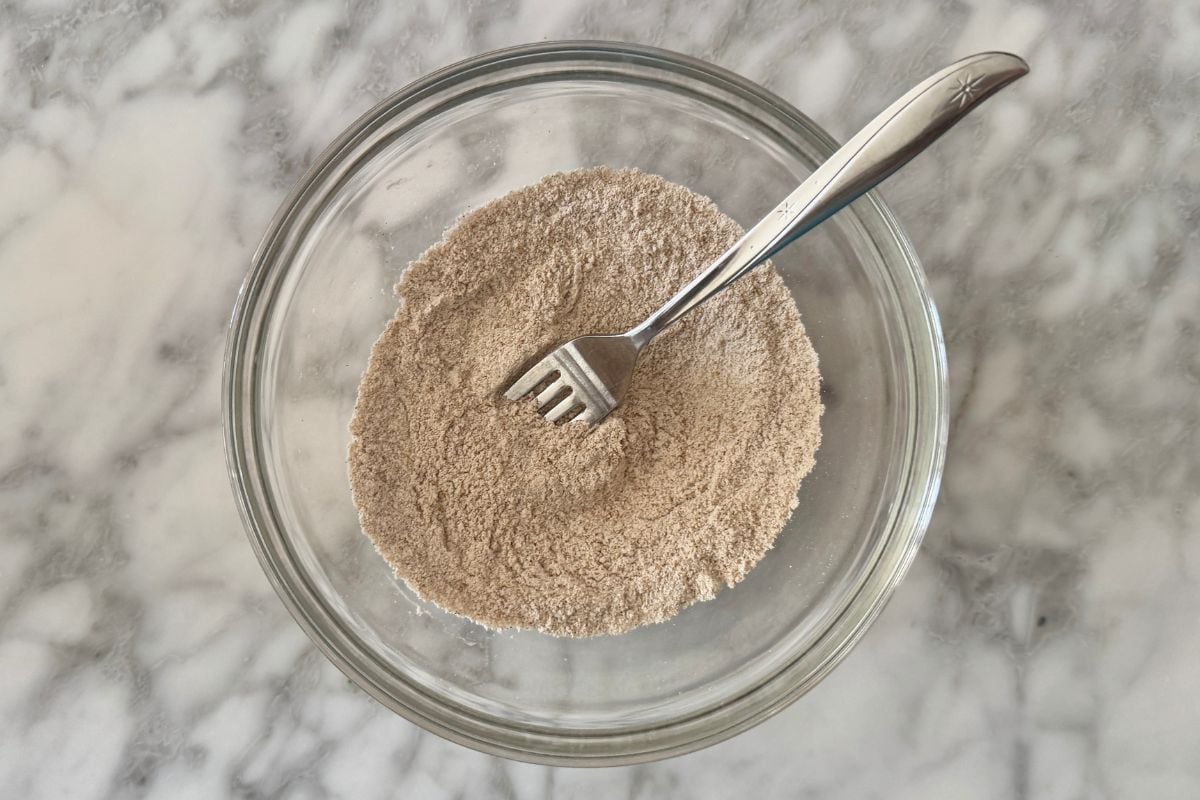 Mixed dry ingredients for carrot cake mug cake in a bowl.