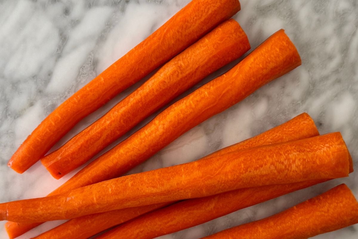Peeled carrots for carrot mug cake.