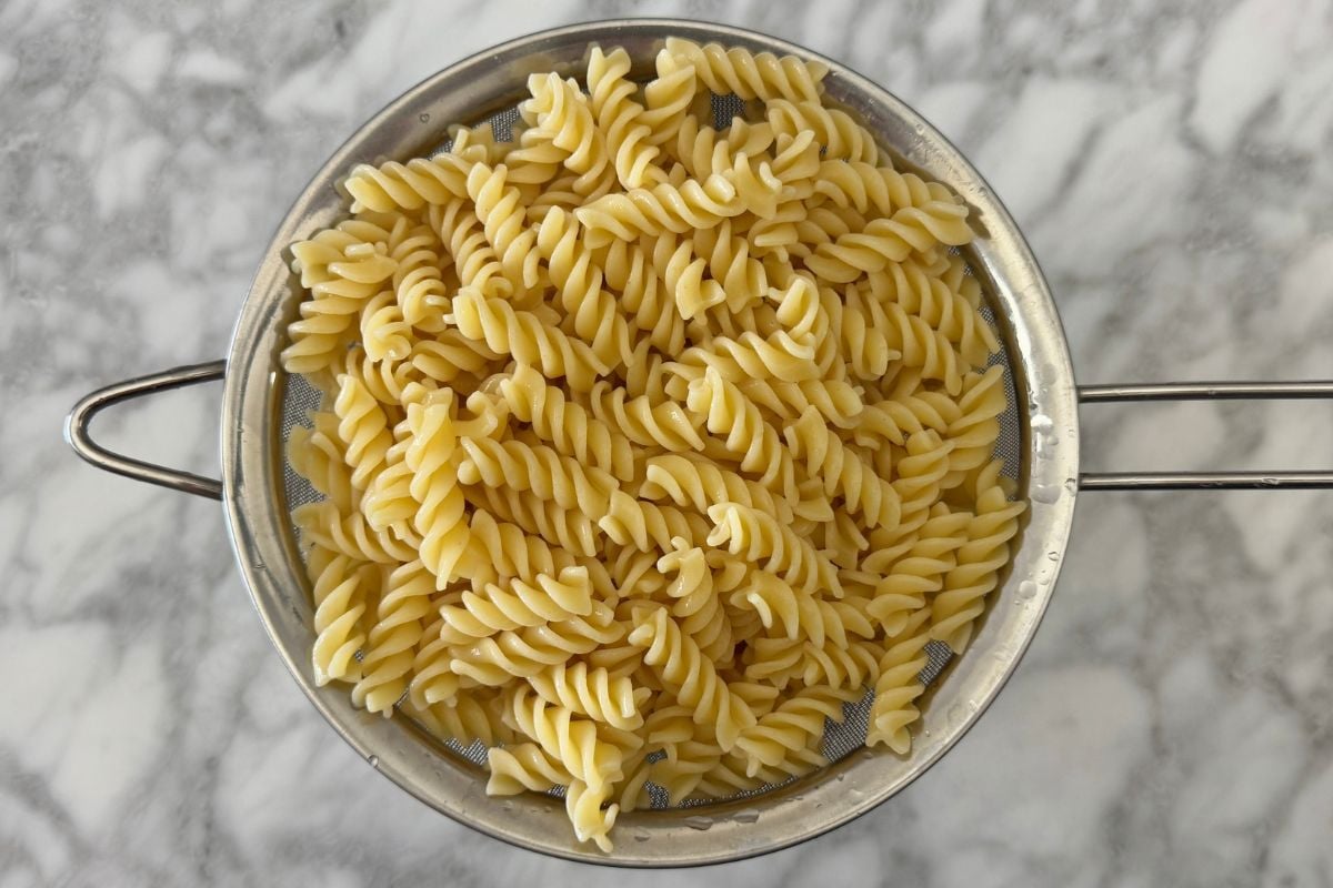 Cooked pasta for pasta salad | Healthy Foodie Girl Cooked pasta for pasta salad in strainer