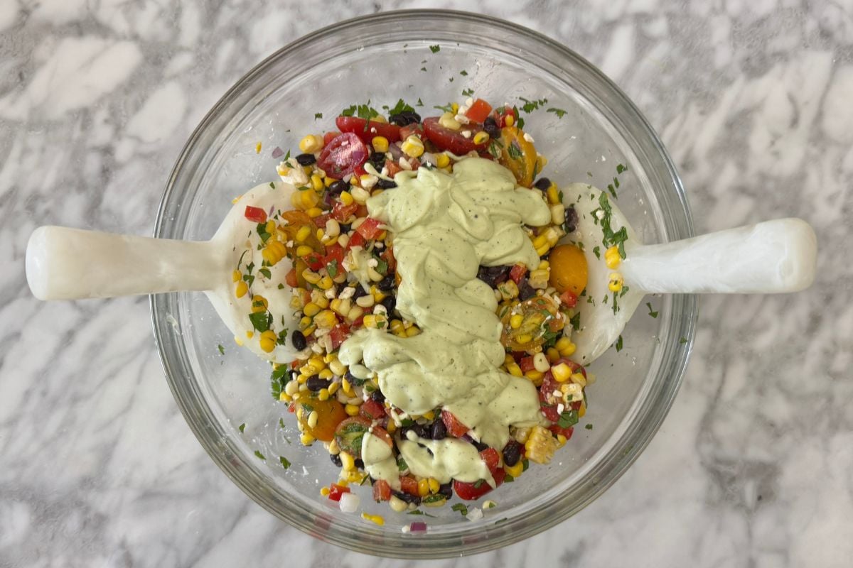 Corn salad with dressing in bowl | Healthy Foodie Girl Corn salad with dressing in bowl