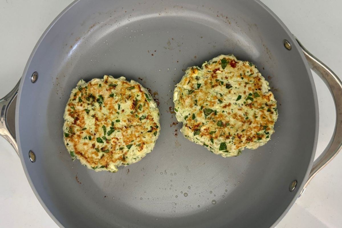 Cooked spinach and feta turkey burgers in pan | Healthy Foodie Girl Cooked spinach and feta turkey burgers in pan
