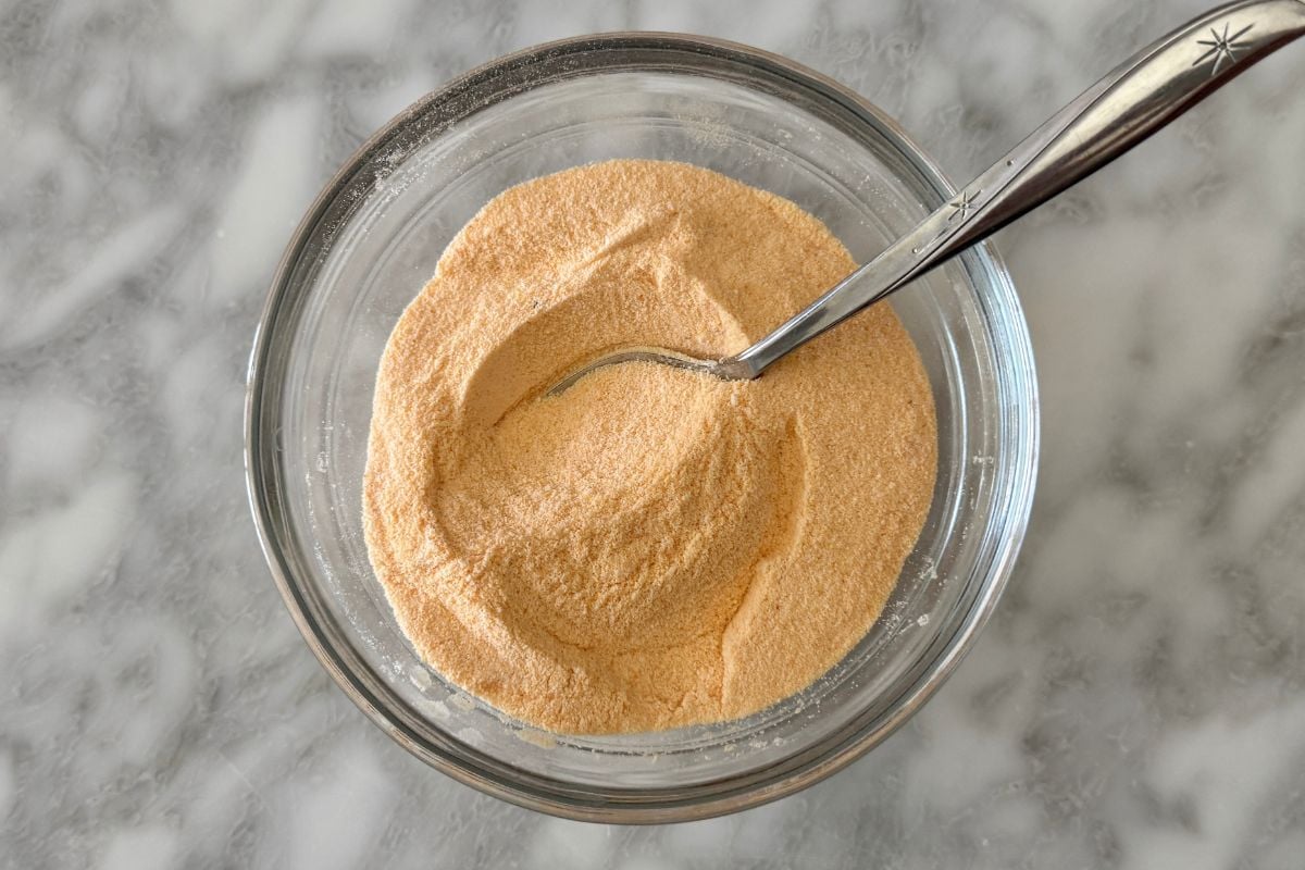 Cheddar seasoning mixture in bowl for cheddar protein popcorn