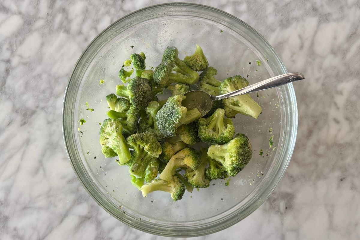 Seasoned frozen broccoli florets in large bowl | Healthy Foodie Girl Seasoned frozen broccoli florets in large bowl