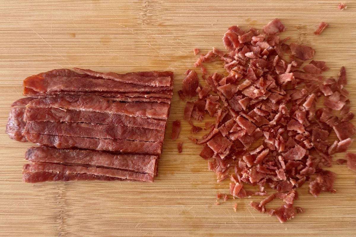 Chopped cooked turkey bacon on cutting board