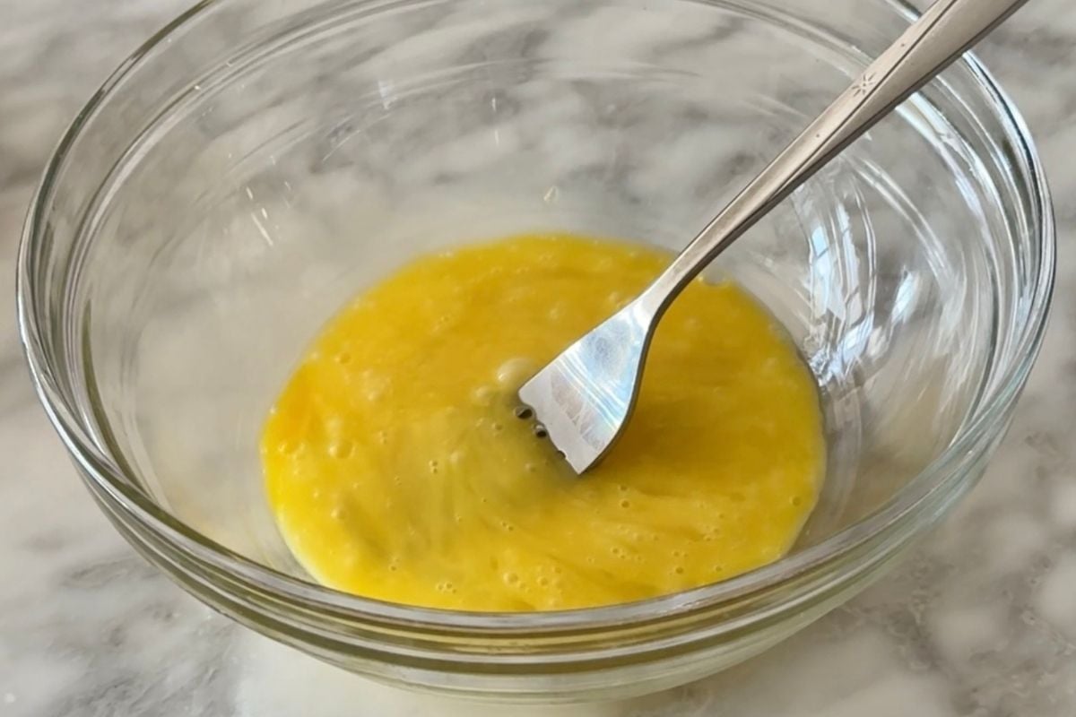 Whisked egg in a bowl for chicken nuggets.