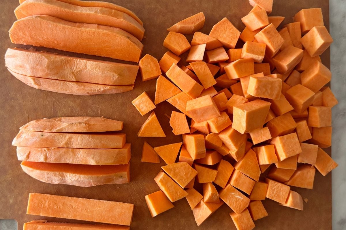 Chopped sweet potatoes on cutting board | Healthy Foodie Girl Chopped sweet potatoes on cutting board.