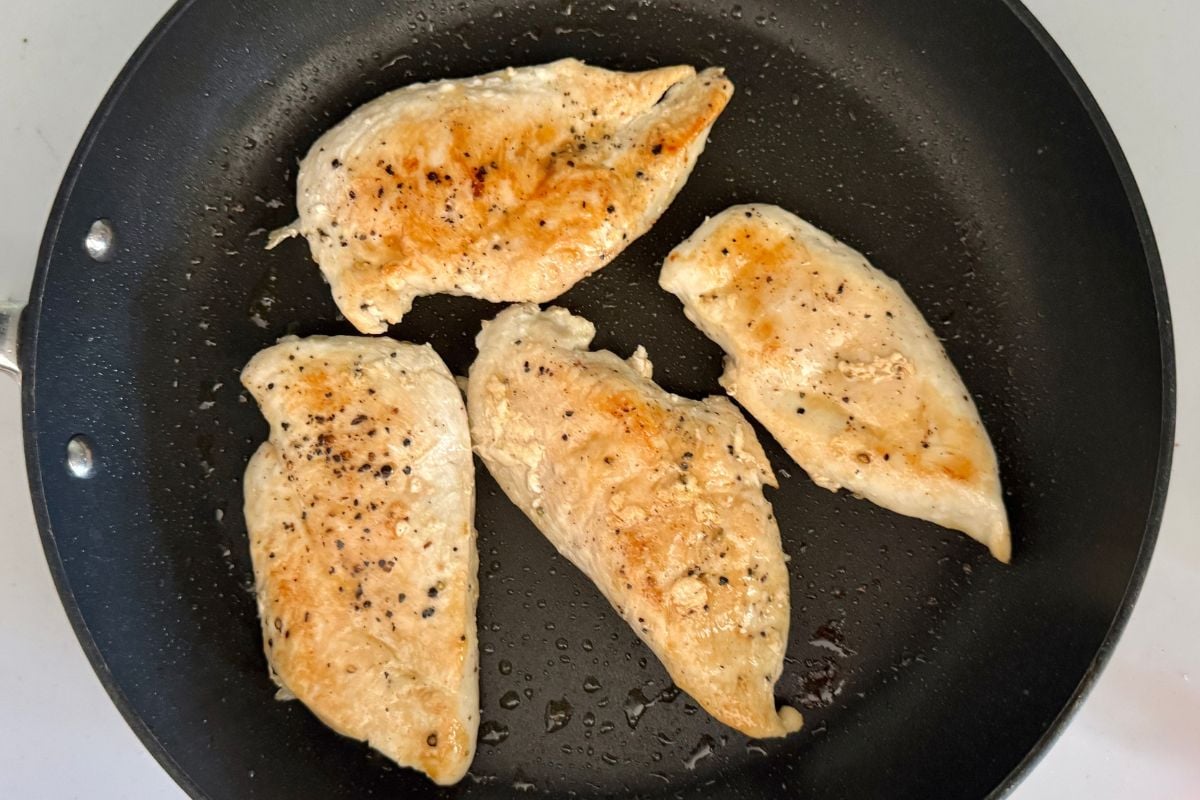 Cooked chicken cutlets in skillet for Marry Me Chicken | Healthy Foodie Girl Cooked chicken cutlets in skillet for Marry Me Chicken