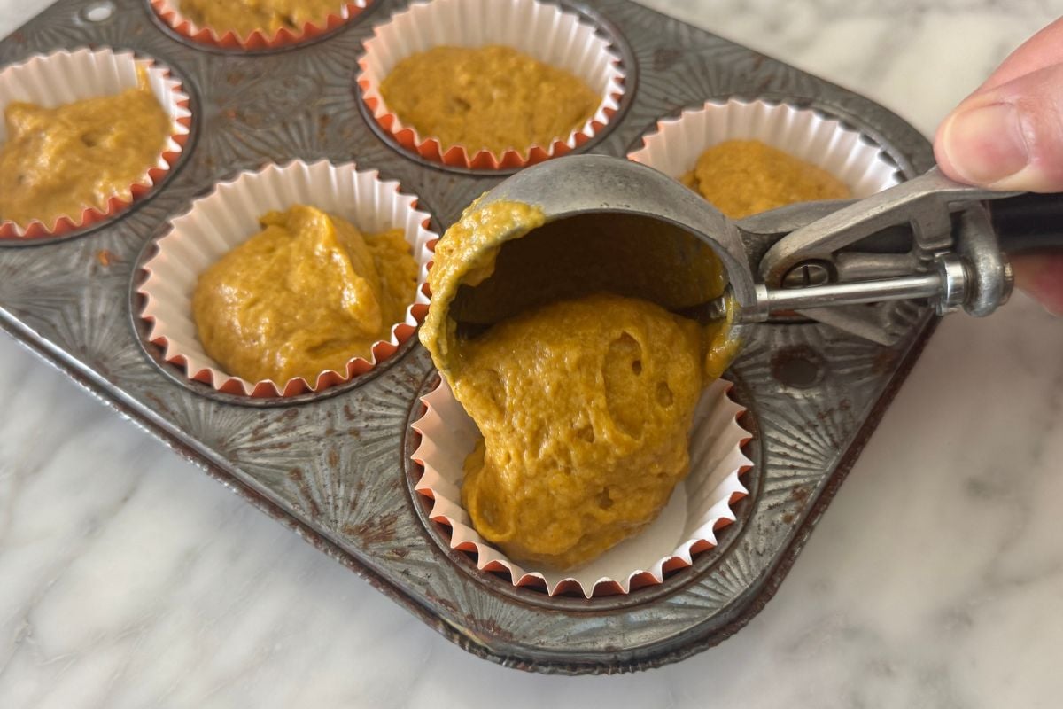 Pumpkin muffin batter in muffin pan