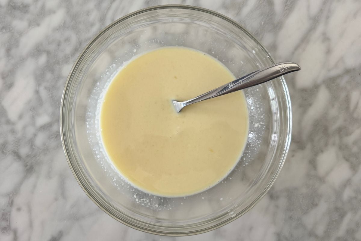 Whisked wet ingredients for cornbread in bowl