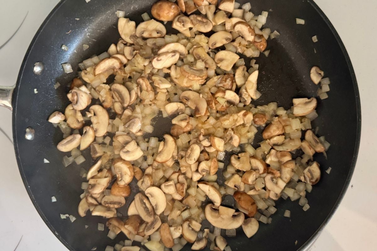 Cooked mushrooms onions and garlic in pan