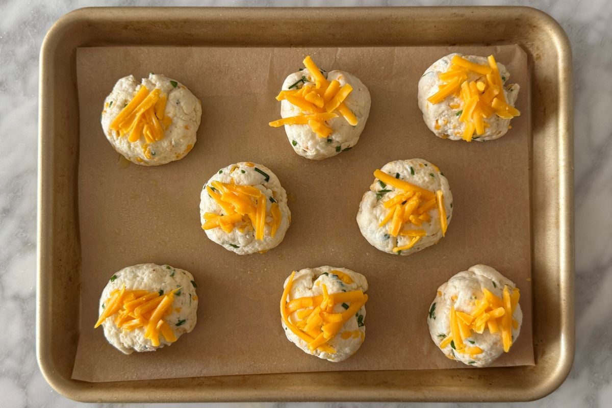 Protein biscuits topped with cheddar on sheet pan | Healthy Foodie Girl Protein biscuits topped with cheddar on sheet pan