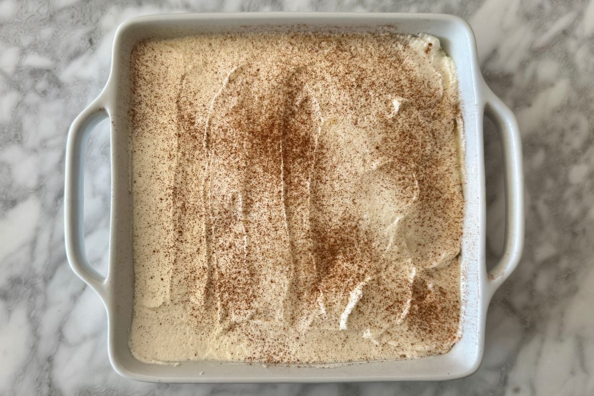 Eggnog tiramisu dusted with cinnamon in dish
