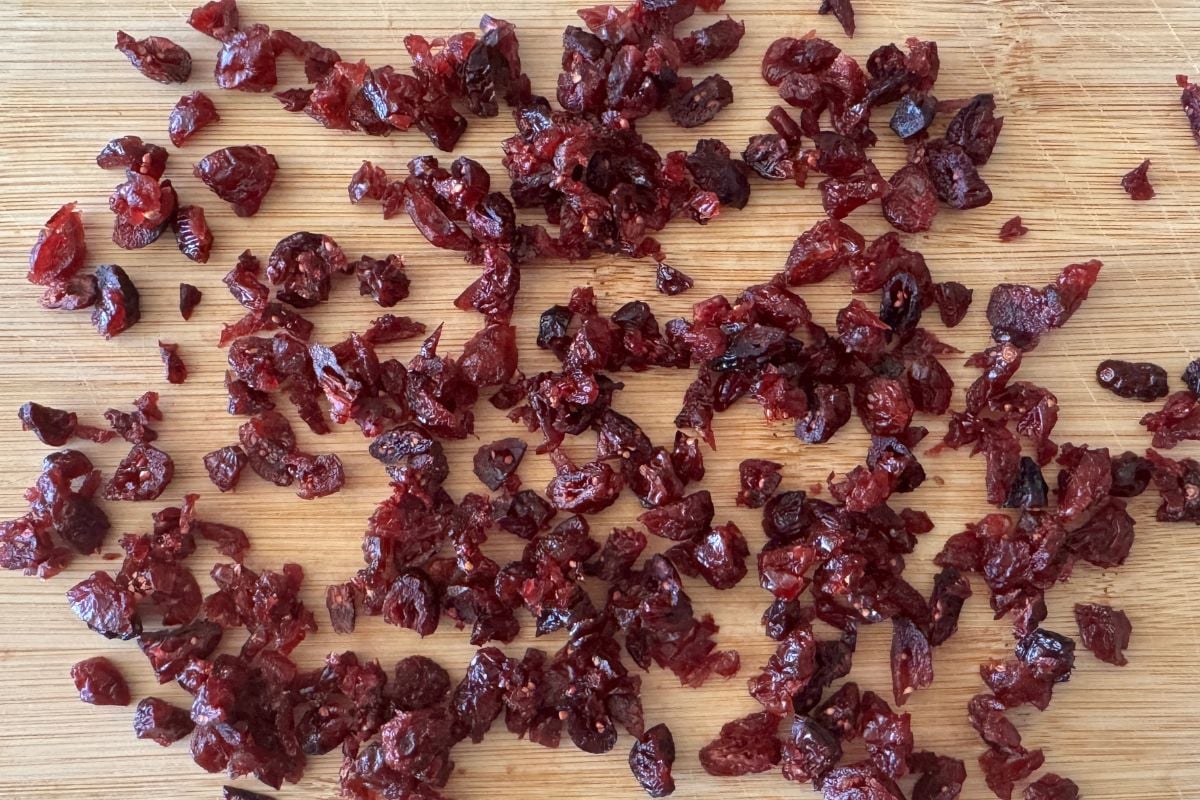 Roughly chopped dried cranberries on a cutting board