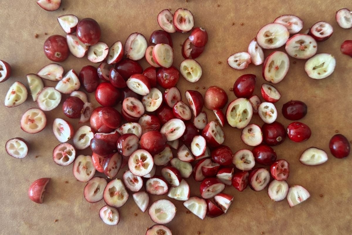 Roughly chopped fresh cranberries on a cutting board