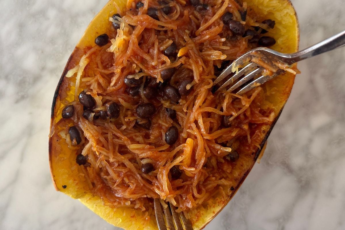 Black beans and enchilada sauce in spaghetti squash