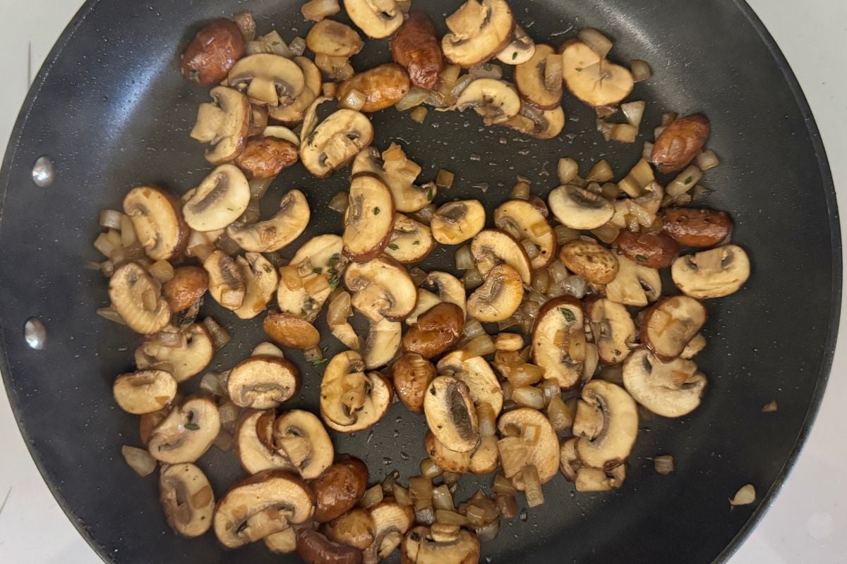 Cooked onions mushrooms and thyme in skillet