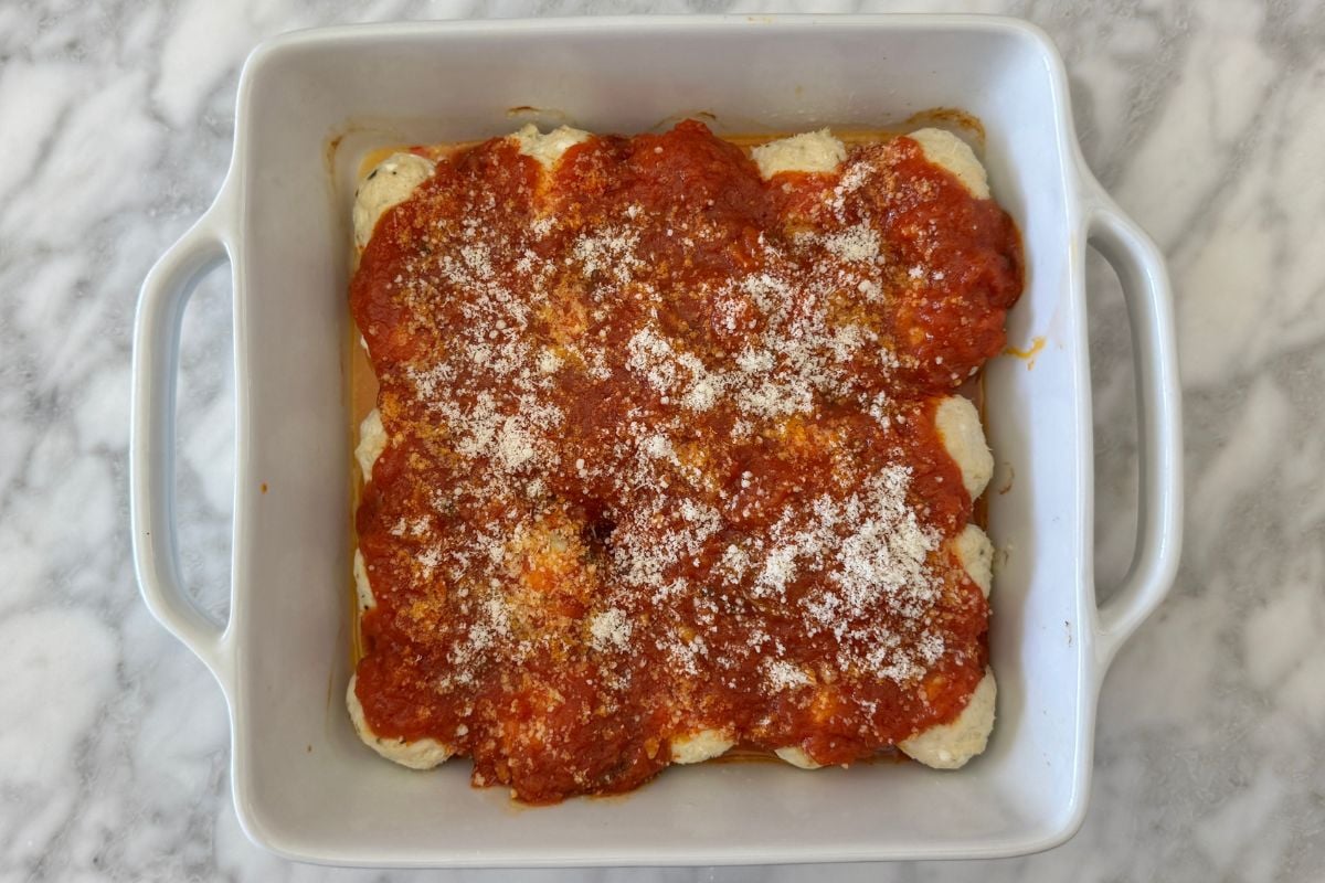 Cottage cheese meatballs topped with marinara sauce and Parmesan cheese.