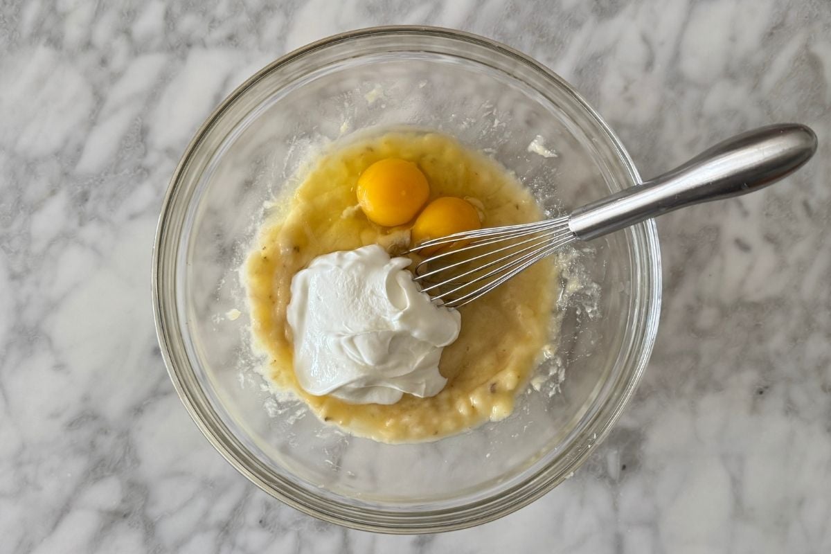 Eggs and Greek yogurt in bowl with mashed bananas