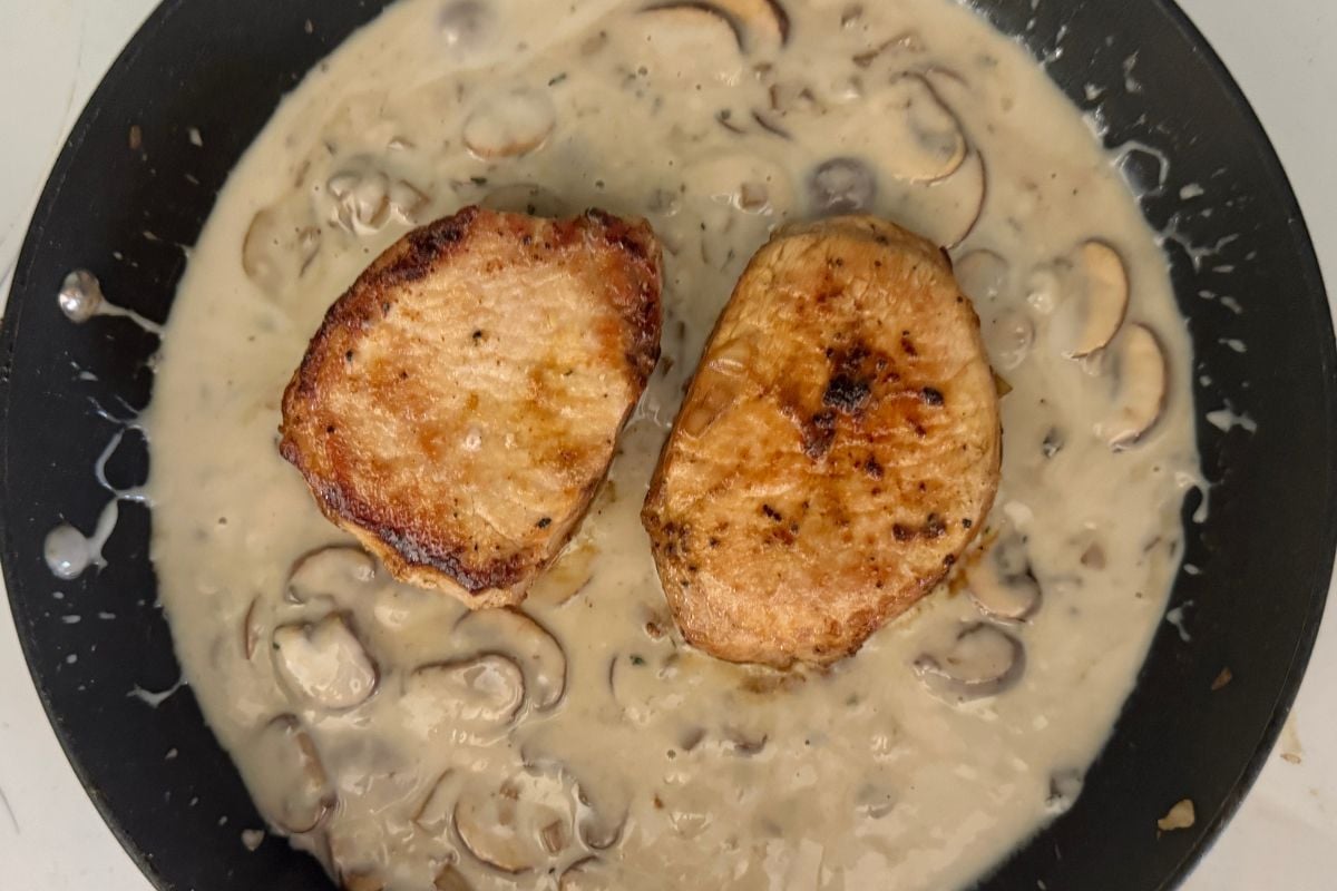 Pork chops in cream of mushroom soup sauce in skillet