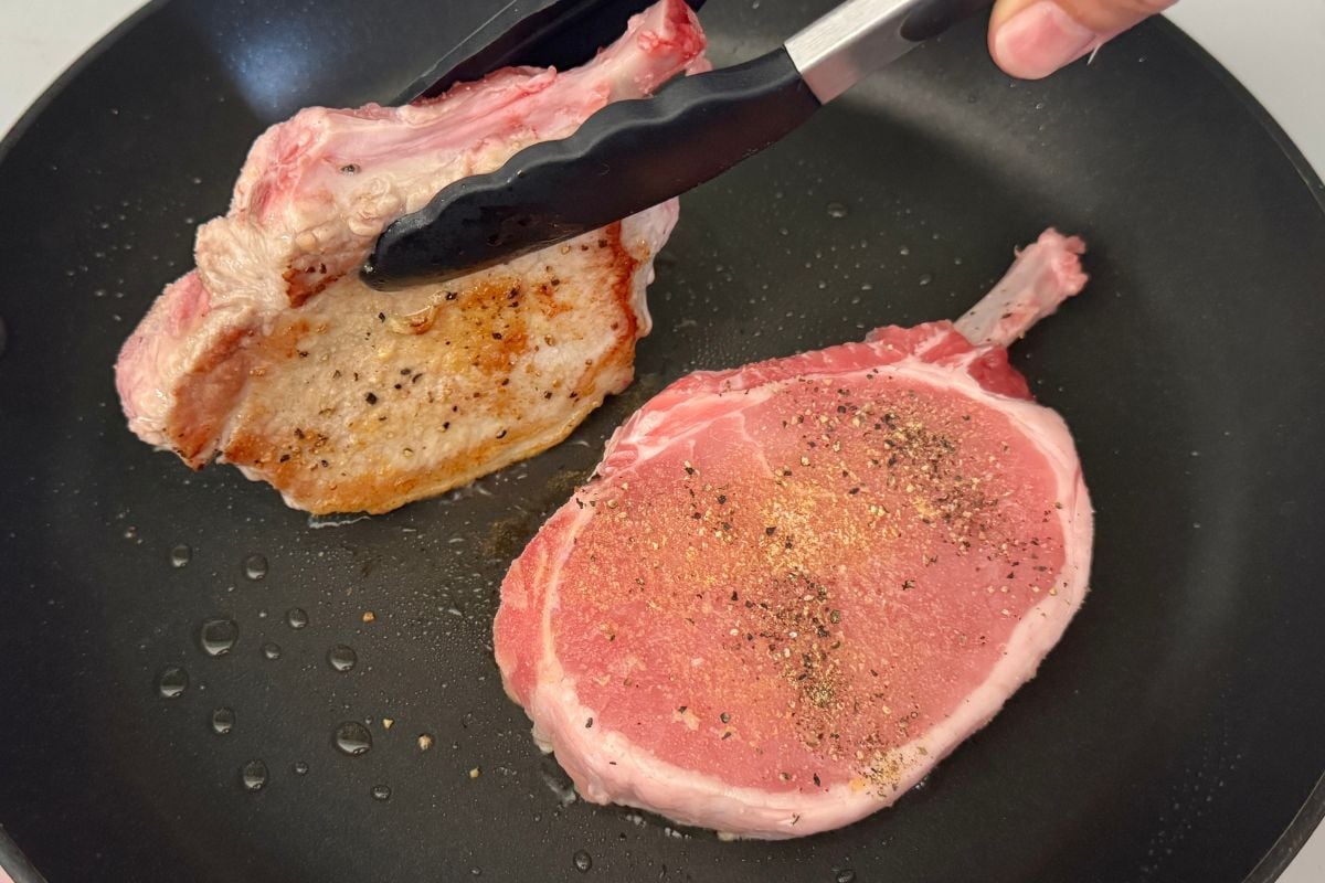 Seasoned pork chops in skillet