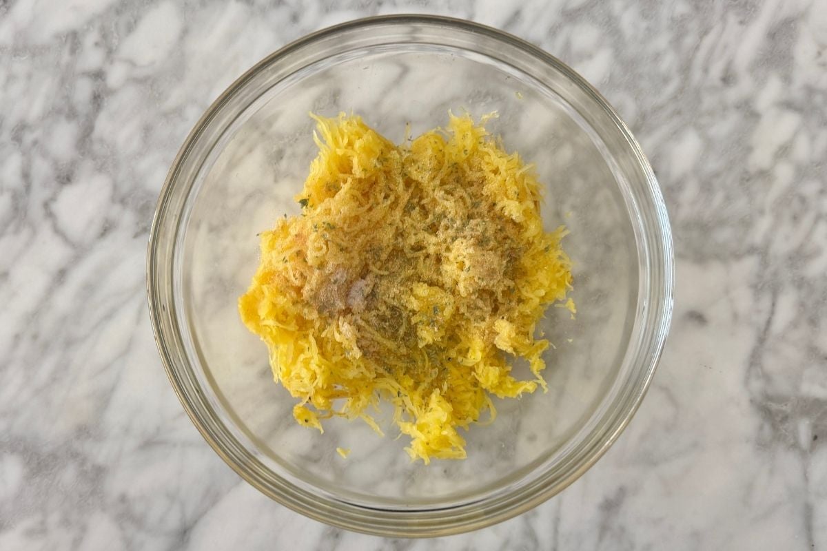 Spaghetti squash strands seasoned in bowl