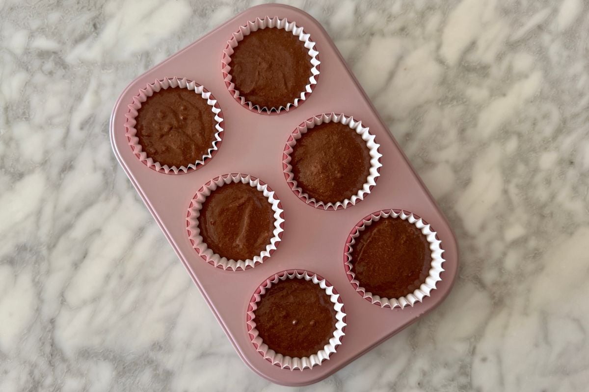Chocolate Kodiak protein muffin batter in muffin pan | Healthy Foodie Girl Chocolate Kodiak protein muffin batter in a muffin pan.
