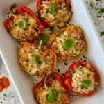 Italian ground turkey stuffed peppers cooked in a baking dish.