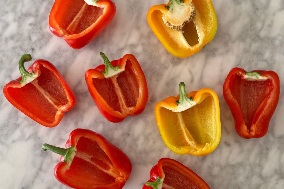 Sliced bell peppers | Healthy Foodie Girl Sliced bell peppers in half lengthwise.