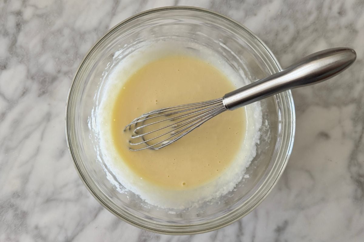 Whisked wet ingredients for chocolate Kodiak muffins in bowl | Healthy Foodie Girl Whisked wet ingredients for chocolate Kodiak muffins in a bowl.