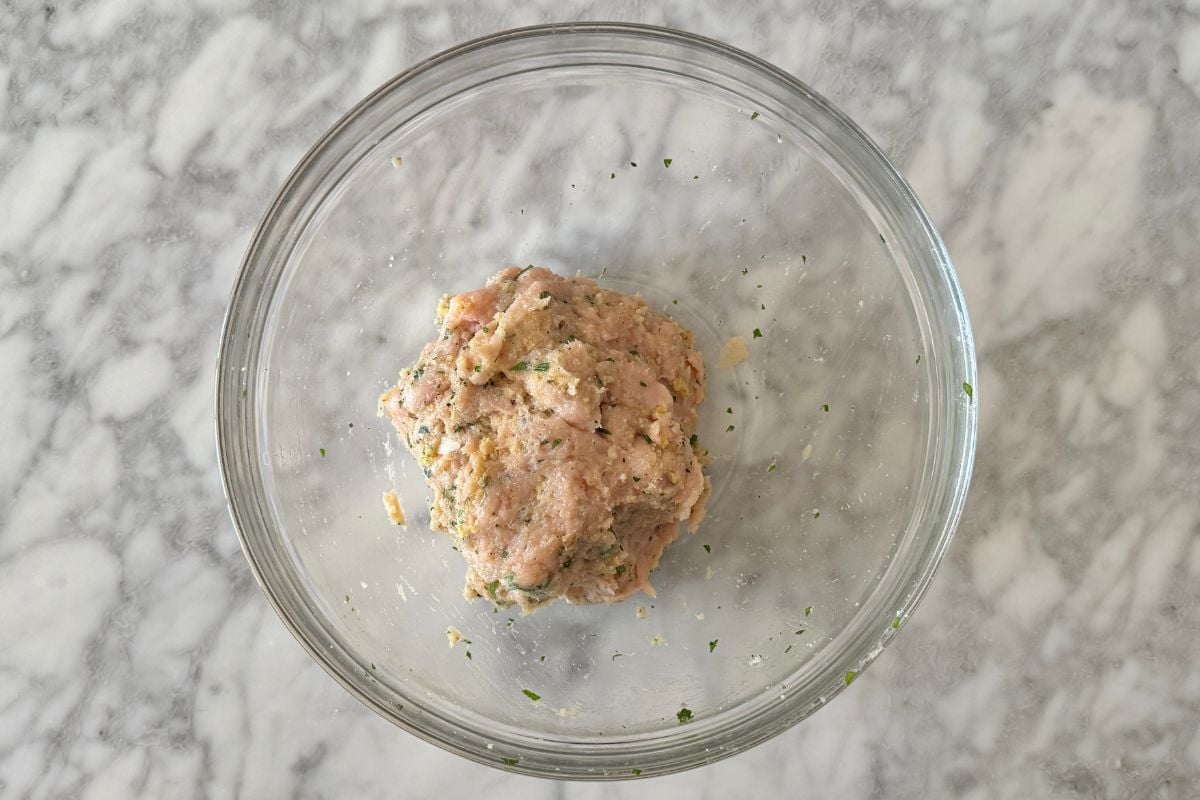 Combined mixture for turkey meatballs in bowl.